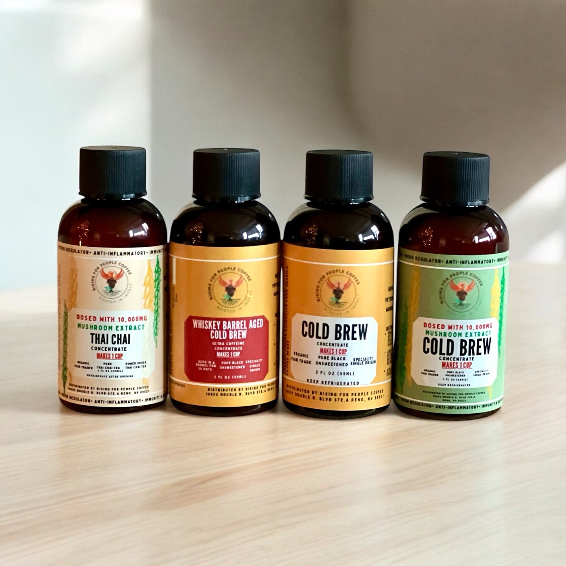 2oz Travel Cold Brew & Thai Chai Tea Concentrated Set of 4 - Rising For People Coffee Co.CoffeeRising For People Coffee Co.Rising For People Coffee Co.Rising for People Coffee concentrate bottles—2oz Travel Cold Brew & Thai Chai Tea Concentrated Set of 4 (Original cold brew, Whiskey Barrel cold brew, Happy Mushroom cold brew, Happy Mushroom Thai chai) Perfect for lattes, baking, cooking, and baking, Latte, Cappuccino, Coffee shop, Coffee shop near, Coffee near me, Roasted coffee, Speciality coff