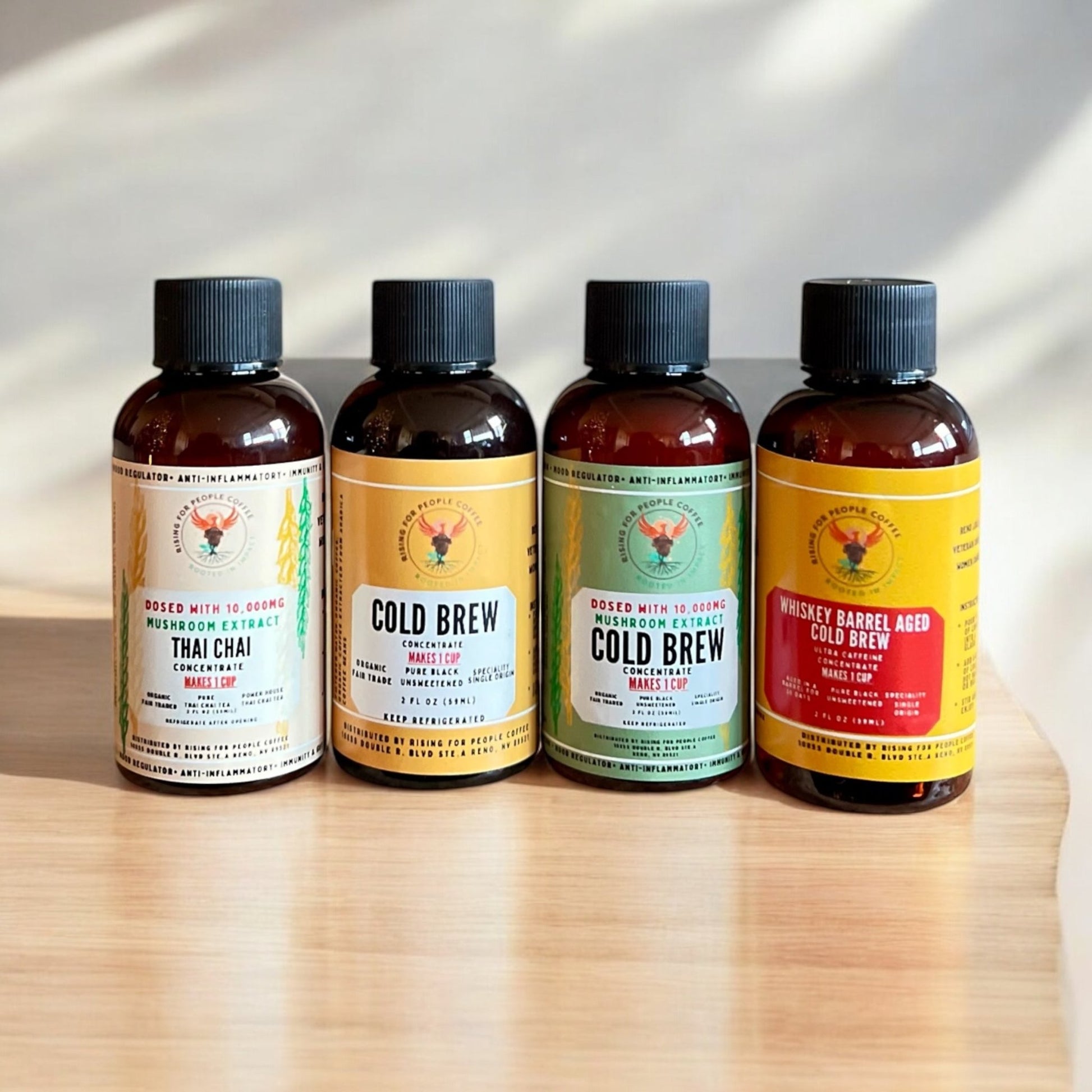 2oz Travel Cold Brew & Thai Chai Tea Concentrated Set of 4 - Rising For People Coffee Co.CoffeeRising For People Coffee Co.Rising For People Coffee Co.Rising for People Coffee concentrate bottles—2oz Travel Cold Brew & Thai Chai Tea Concentrated Set of 4 (Original cold brew, Whiskey Barrel cold brew, Happy Mushroom cold brew, Happy Mushroom Thai chai) Perfect for lattes, baking, cooking, and baking, Latte, Cappuccino, Coffee shop, Coffee shop near, Coffee near me, Roasted coffee, Speciality coff
