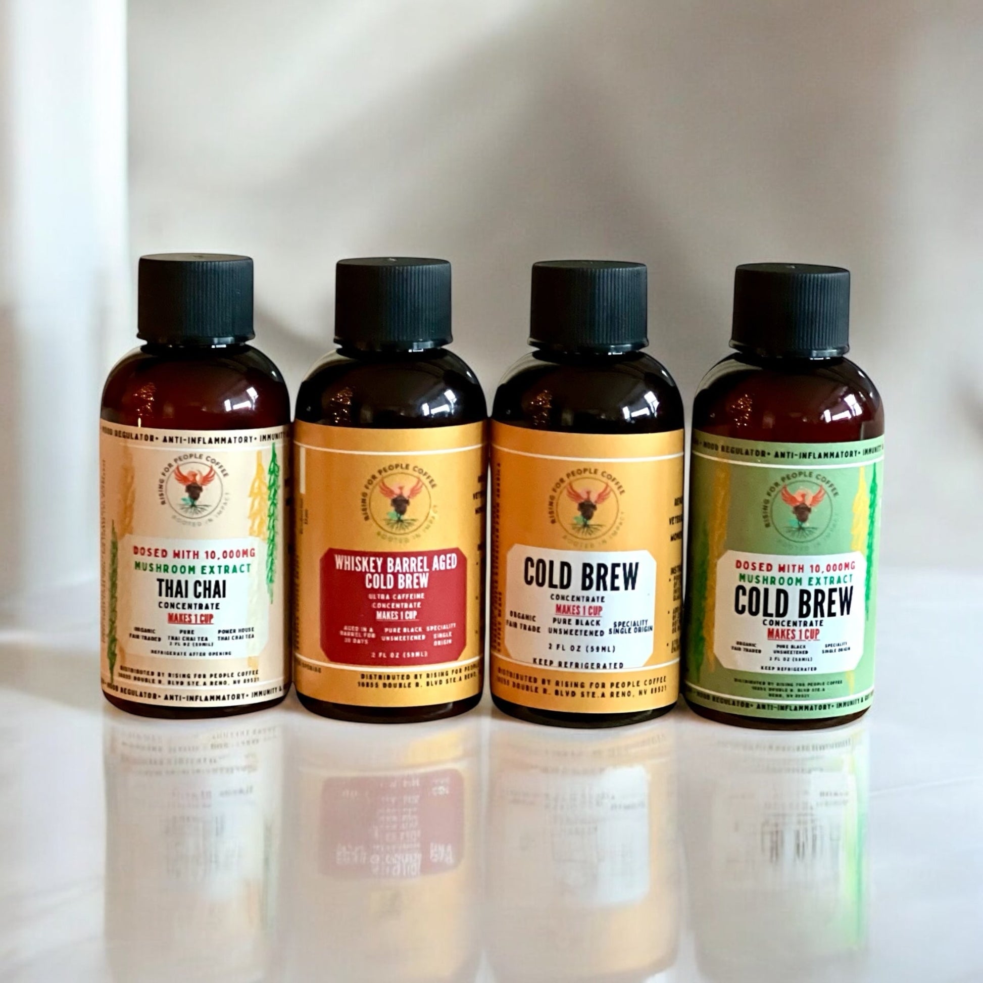2oz Travel Cold Brew & Thai Chai Tea Concentrated Set of 4 - Rising For People Coffee Co.CoffeeRising For People Coffee Co.Rising For People Coffee Co.Rising for People Coffee concentrate bottles—2oz Travel Cold Brew & Thai Chai Tea Concentrated Set of 4 (Original cold brew, Whiskey Barrel cold brew, Happy Mushroom cold brew, Happy Mushroom Thai chai) Perfect for lattes, baking, cooking, and baking, Latte, Cappuccino, Coffee shop, Coffee shop near, Coffee near me, Roasted coffee, Speciality coff