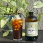 Happy Mushroom Cold Brew & Thai Chai Concentrate - Rising For People Coffee Co.CoffeeRising For People Coffee Co.Rising For People Coffee Co.Rising For people coffee mushroom cold brew coffee bottle. Specialty gourmet concentrated cold brew dosed with lions mane, Chaga, Cordyceps, turkey tail, Reishi - video Latte, Cappuccino, Coffee shop, Coffee shop near, Coffee near me, Roasted coffee, Speciality coffee, Green coffee, Black coffee, Espresso machine, French press, Espresso, Takeout coffee near
