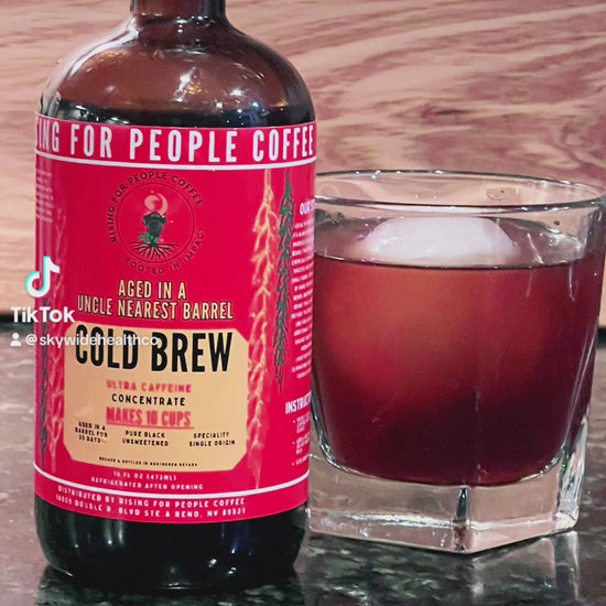 Rising for People Coffee cold brew bottle- organic specialty Guatemala coffee aged in an uncle nearest whiskey barrel for 30 days, roast light, ultra caffeine, Latte,
Cappuccino, 
Coffee shop,
Coffee shop near, 
Coffee near me,
Roasted coffee,
Speciality coffee,
Green coffee,
Black coffee,
Espresso machine,
French press,
Espresso,
Takeout coffee near